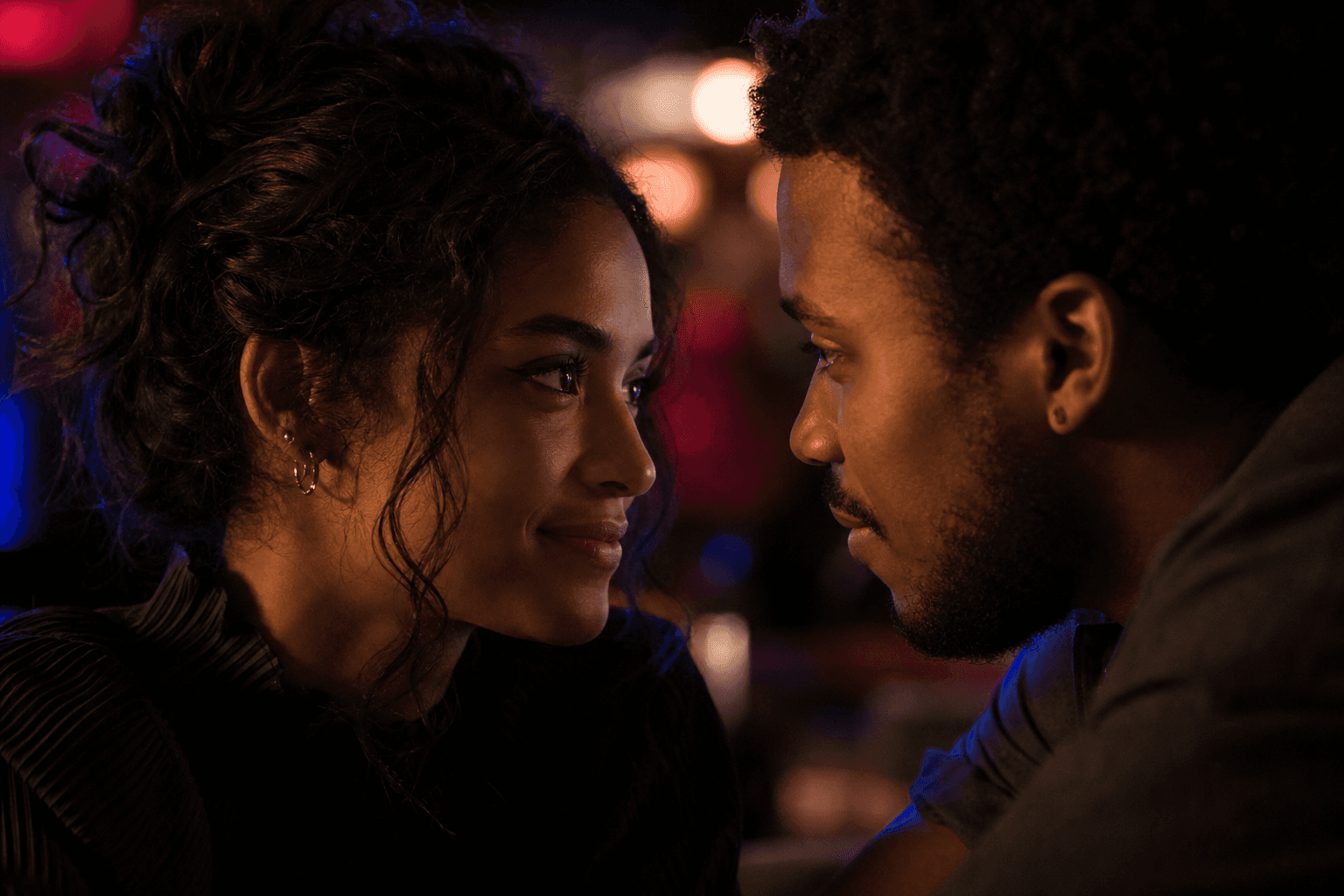 Two people locking eyes in a charged moment of mutual recognition.